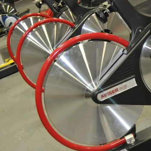 A row of stationary bike wheels