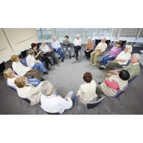 A support group of adults with chairs in a circle